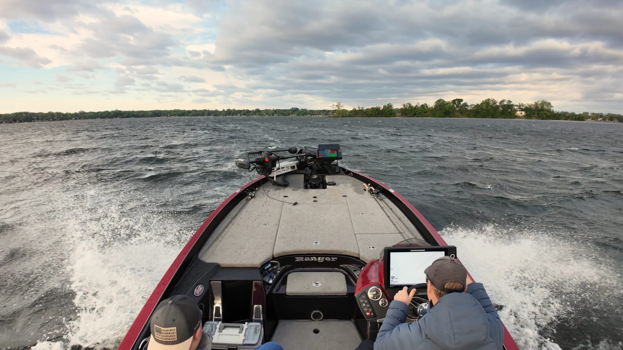 Two anglers driving across choppy water to a fishing spot